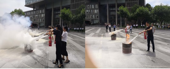 参加演练人员正在进行消防器材操作演练